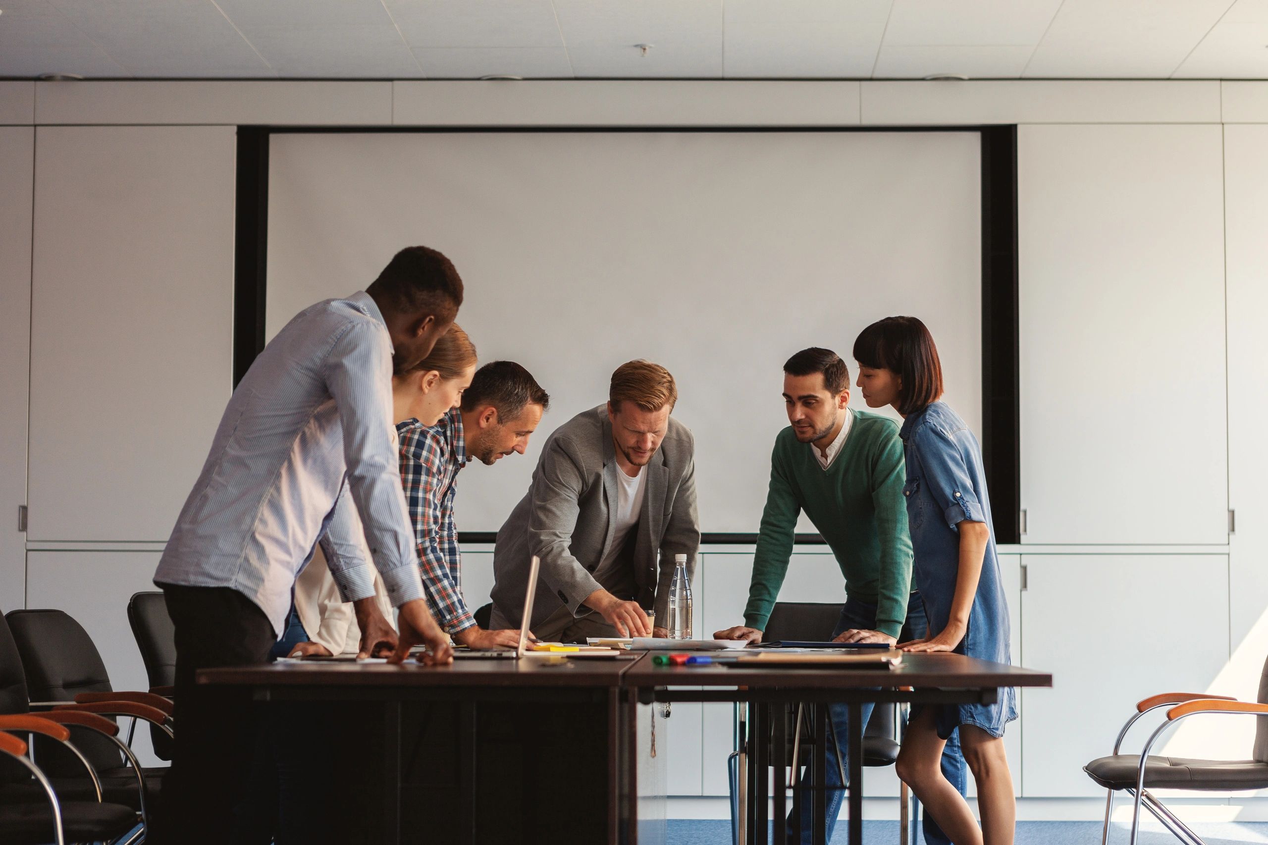 Diverse business team discussing documents around a table
