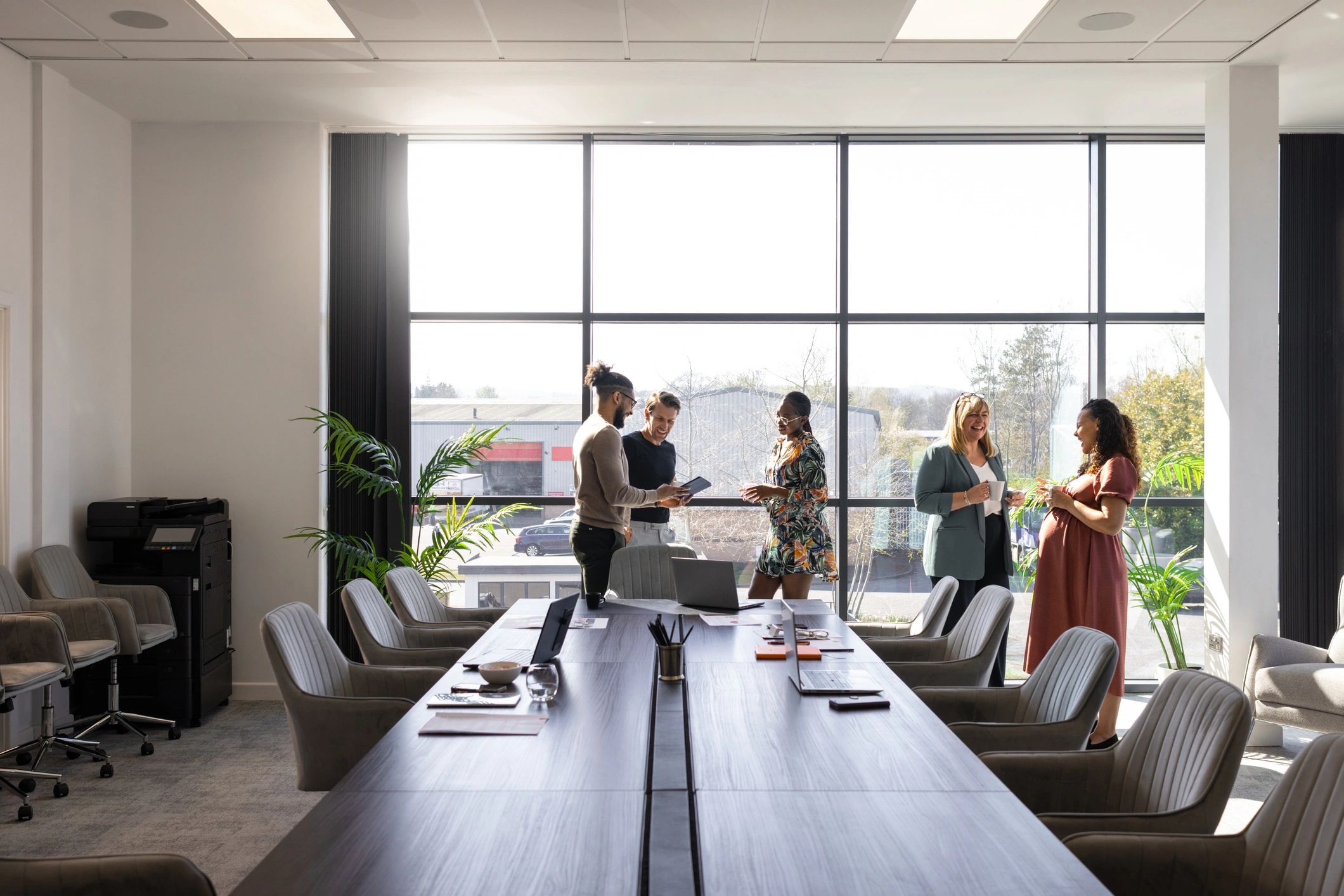 Professional colleagues discussing project progress in a modern office
